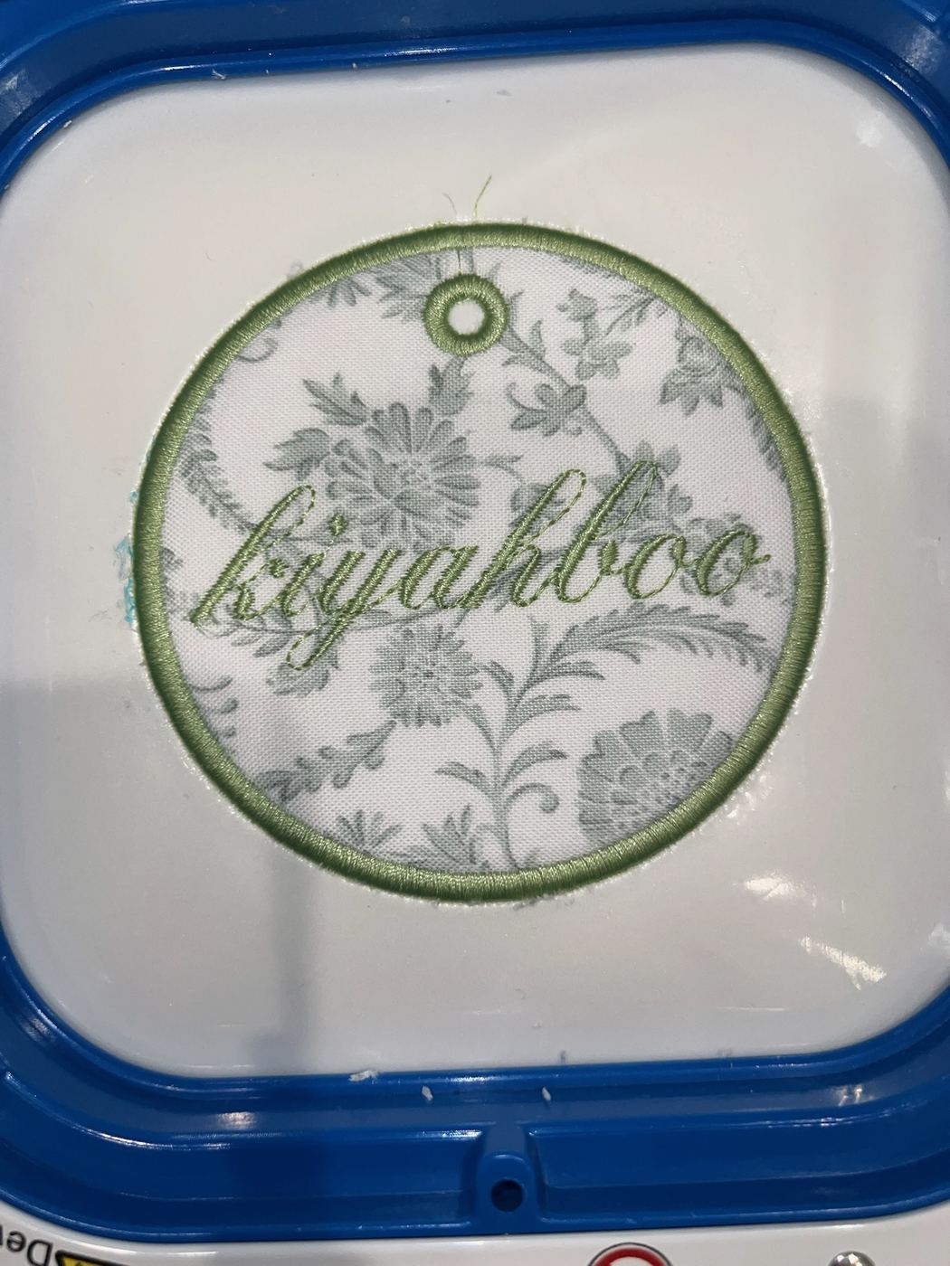 Round floral gift tag embroidered with a nickname in script