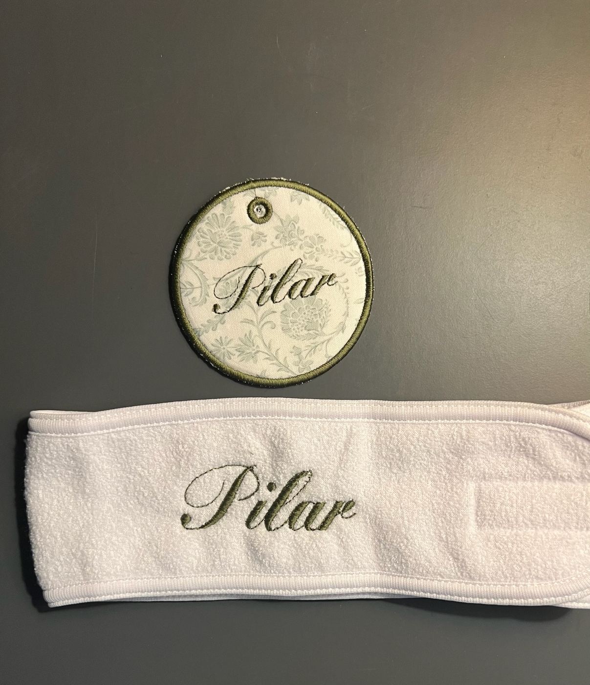 Terry towel and matching floral tag with a custom script name in olive