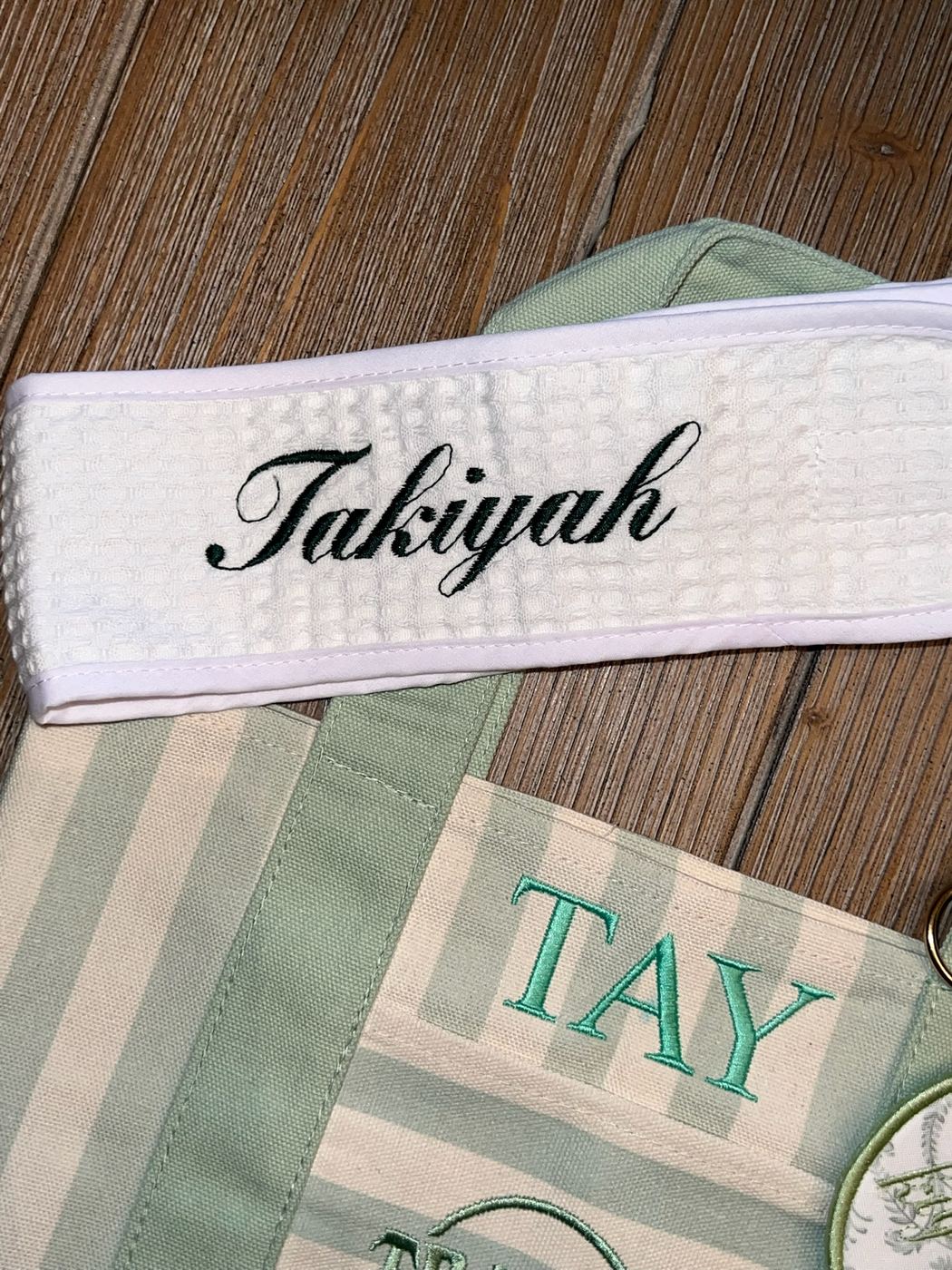 Waffle-weave towel with a custom script name in forest green