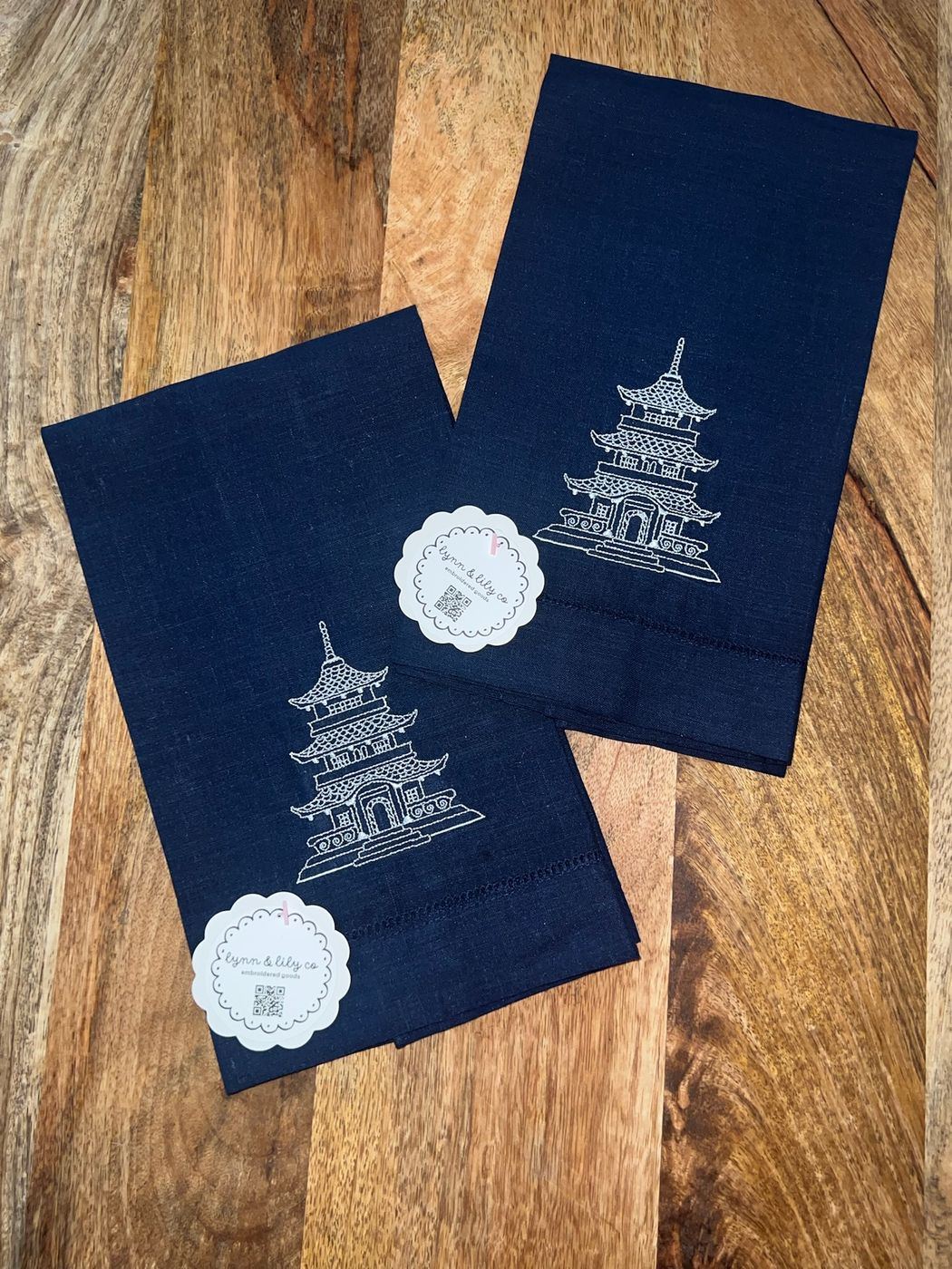 Navy linen tea towels embroidered with a white pagoda